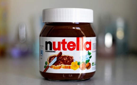 Paris, France - February 22, 2012: Jar of Nutella Hazelnut on a bokeh background. Nutella is the brand name of a chocolate hazelnut flavored sweet spread by the Italian company Ferrero.