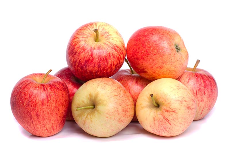 Close up view of a bunch of royal gala apples isolated on a white background.
